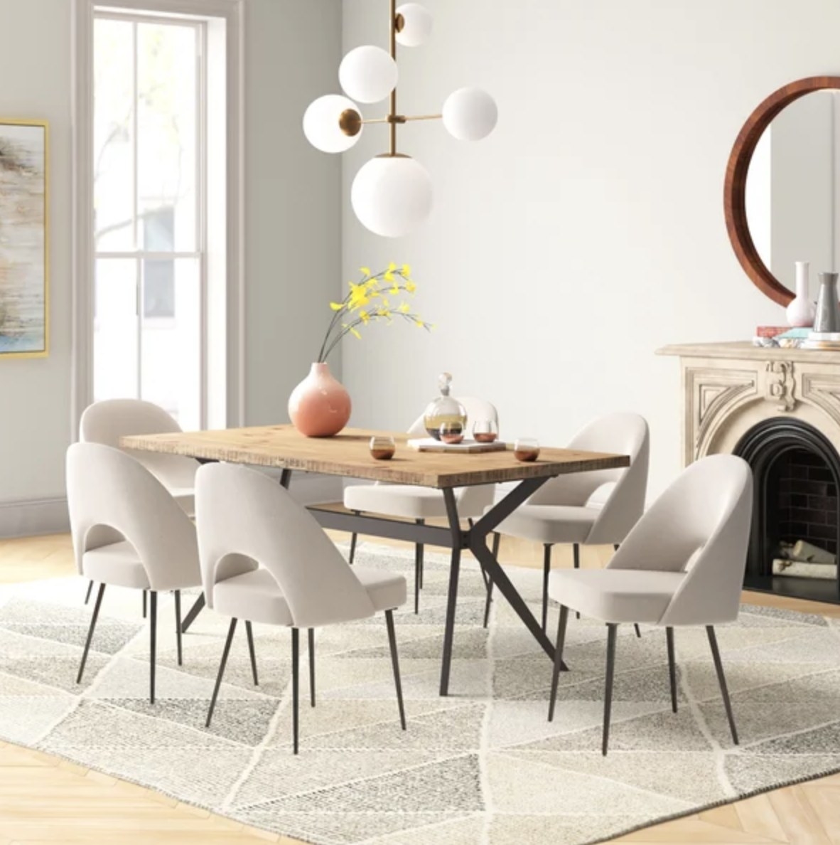 The dining set has a light wooden table and six white soft chairs