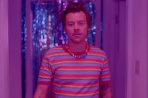 Harry Styles walking down a hallway in the Daylight music video