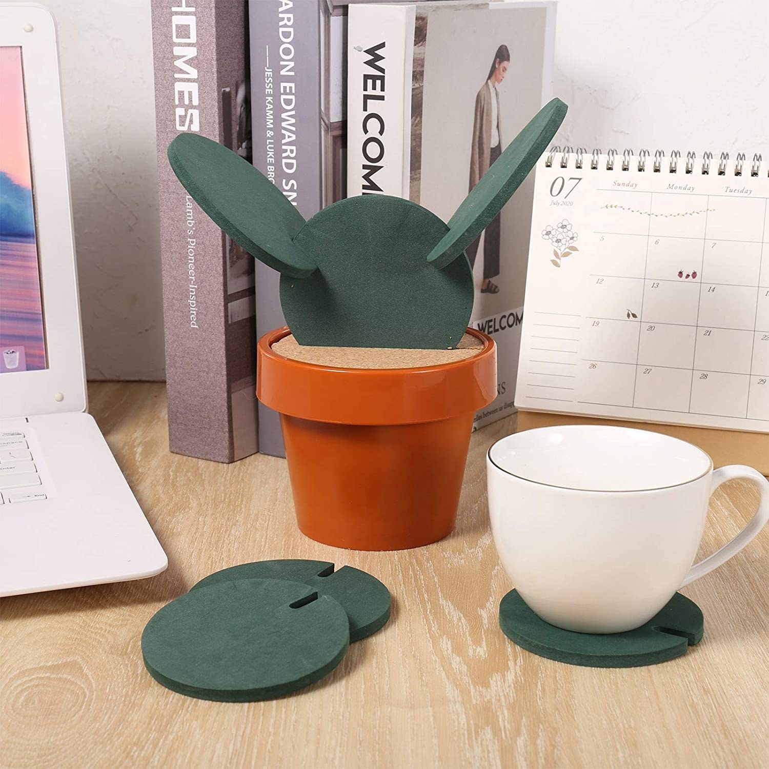 The cactus coasters on a table, one with a mug on top of it
