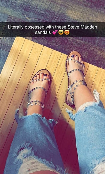 a reviewer wearing the sandals with a text overlay that says 