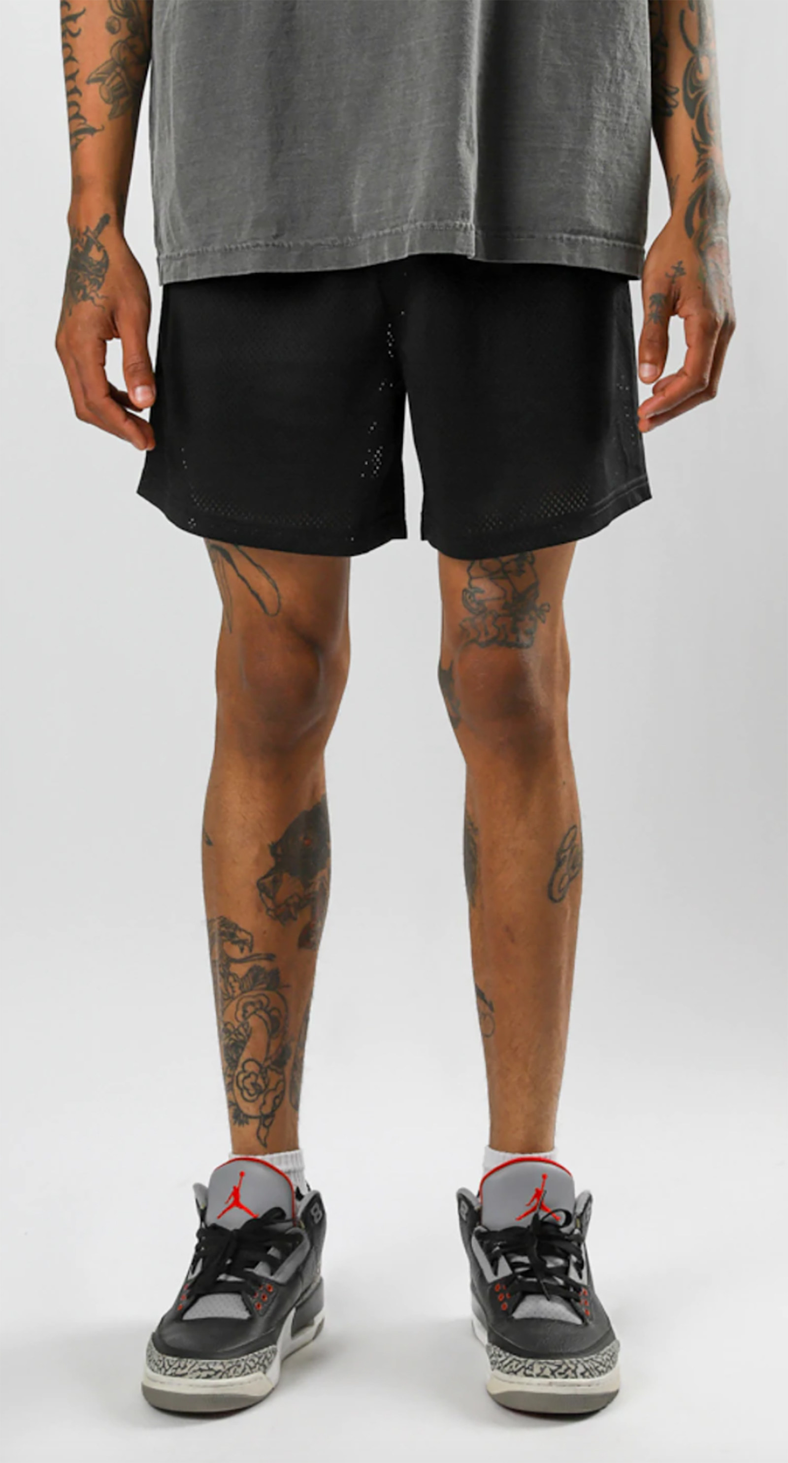 A model wears Superline Wholesale mesh shorts