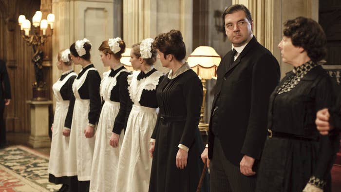 DOWNTON ABBEY, Siobhan Finneran (3rd from right, head turned), Brendan Coyle (2nd from right), Phyllis Logan (right), 2010-2015
