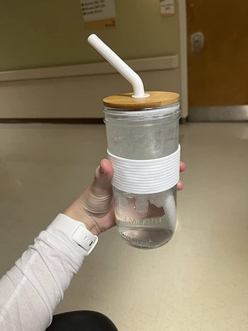Reviewer holding glass filled with water