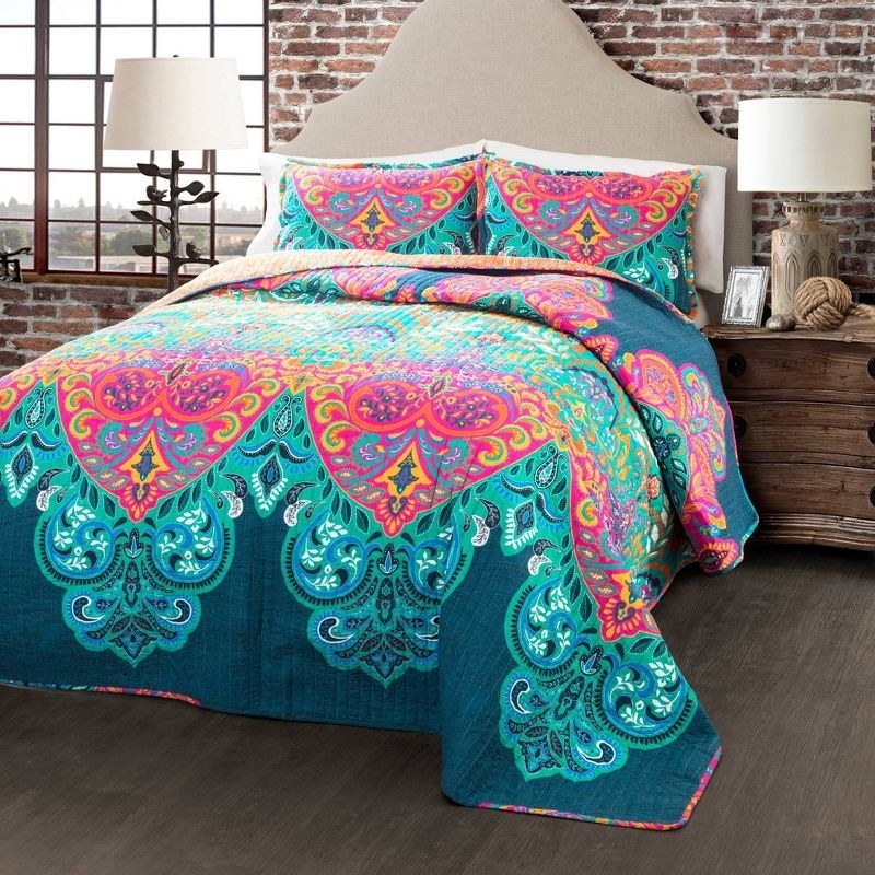 Multicolored quilt set on bed in bedroom