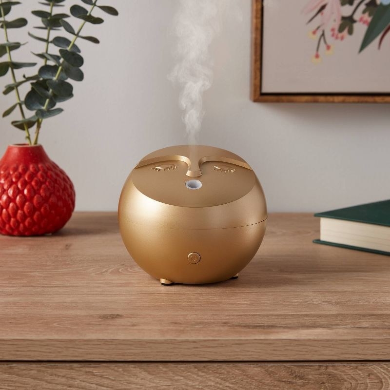 Golden diffuser on top of wooden table