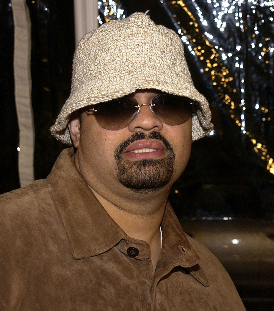 Heavy D in a knit bucket hat and sunglasses
