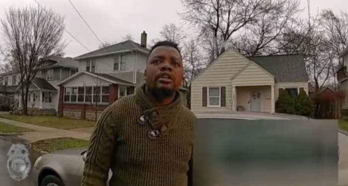 A man wearing a sweater looks toward the viewer in this image from a police body camera