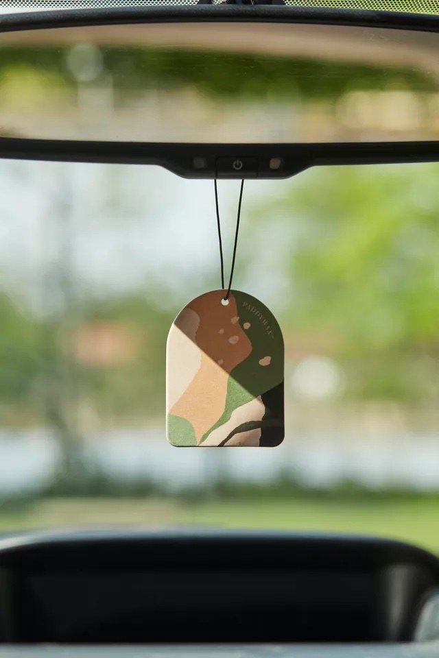A freshener hanging from the mirror in a car