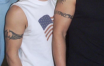 Examples of those tattoos on the upper arms of two men wearing sleeveless shirts