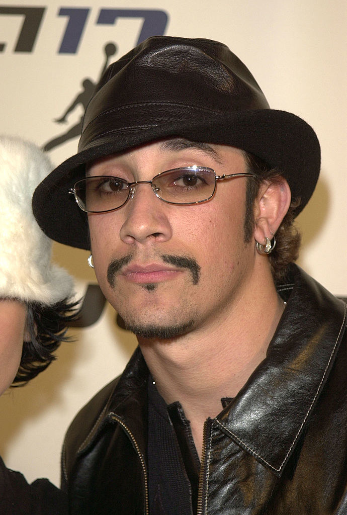 AJ McLean in a hat and thin, angled mustache