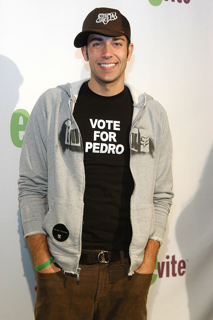 A man wearing a Vote for Pedro shirt with a cap