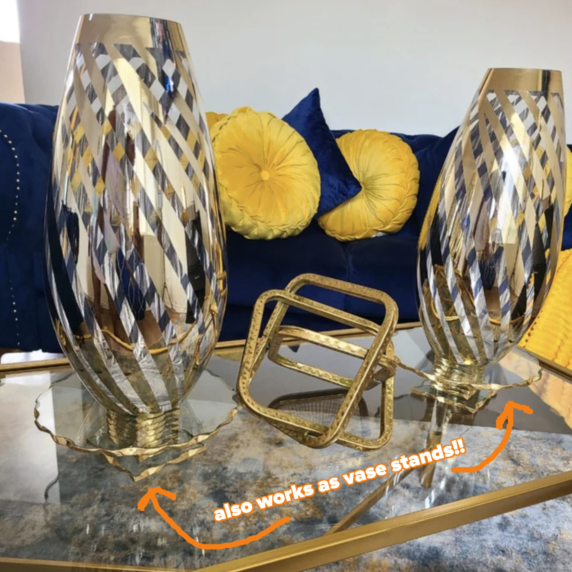 two of the gold and glass cake stands being used to hold up vases
