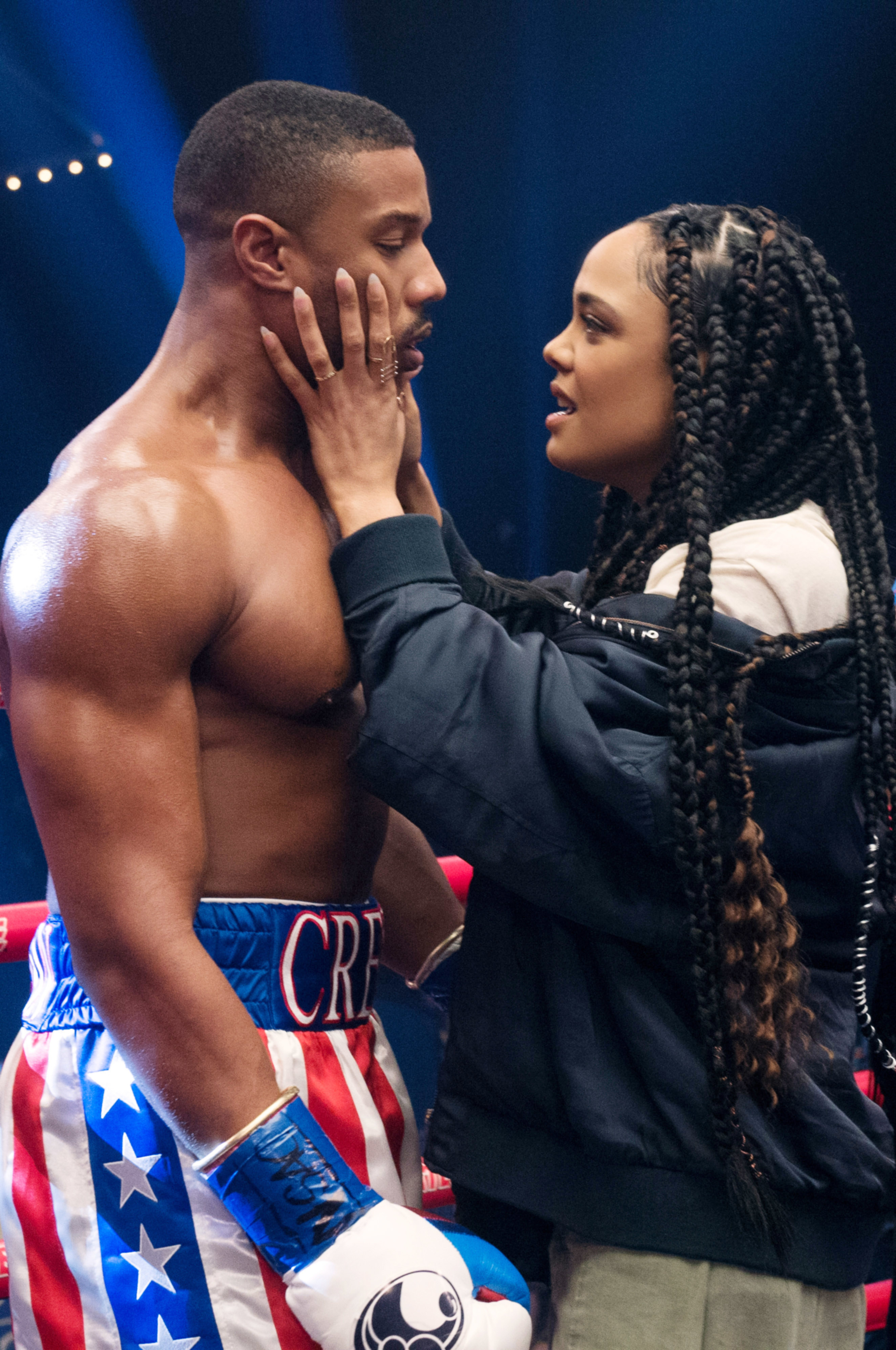 Tessa holding Michael&#x27;s face as she talks to him inside a boxing ring in a scene from Creed