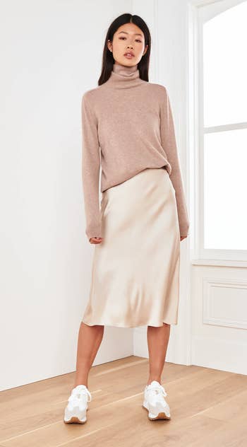 model wearing cream midi skirt