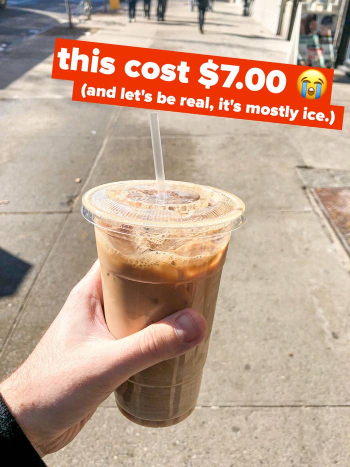 author holding up iced coffee in plastic cup with text &quot;this cost $7.00, and let&#x27;s be real, it&#x27;s mostly ice.&quot;