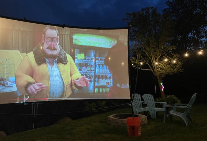 reviewer image of the screen playing a movie in a backyard