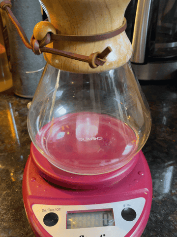 GIF of filling Chemex brewer with ice while on a kitchen scale