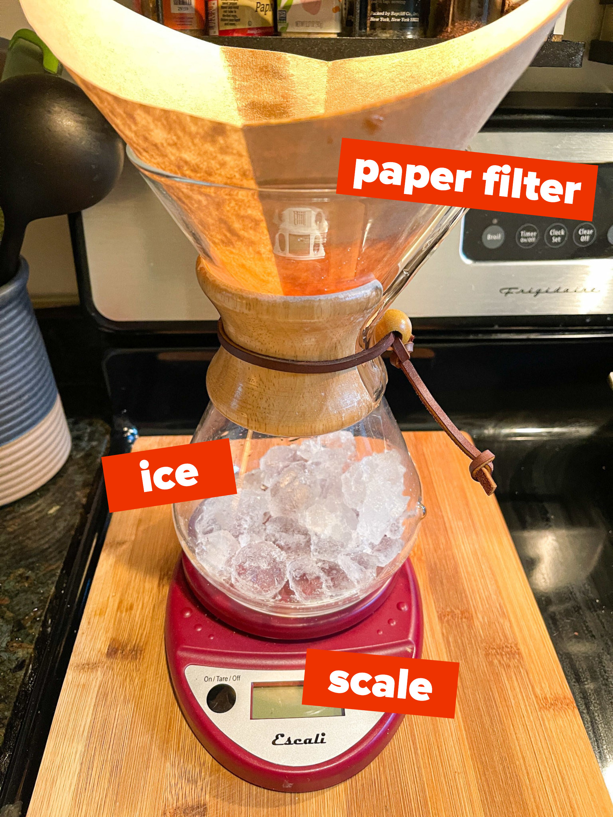 Setup for Japanese iced coffee with a paper filter in the Chemex brewer, ice in the vessel, all on top of a scale