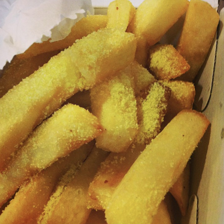 A close up of hot chips with chicken salt