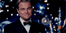 leo raising a glass and smiling in a clip of the great gatsby