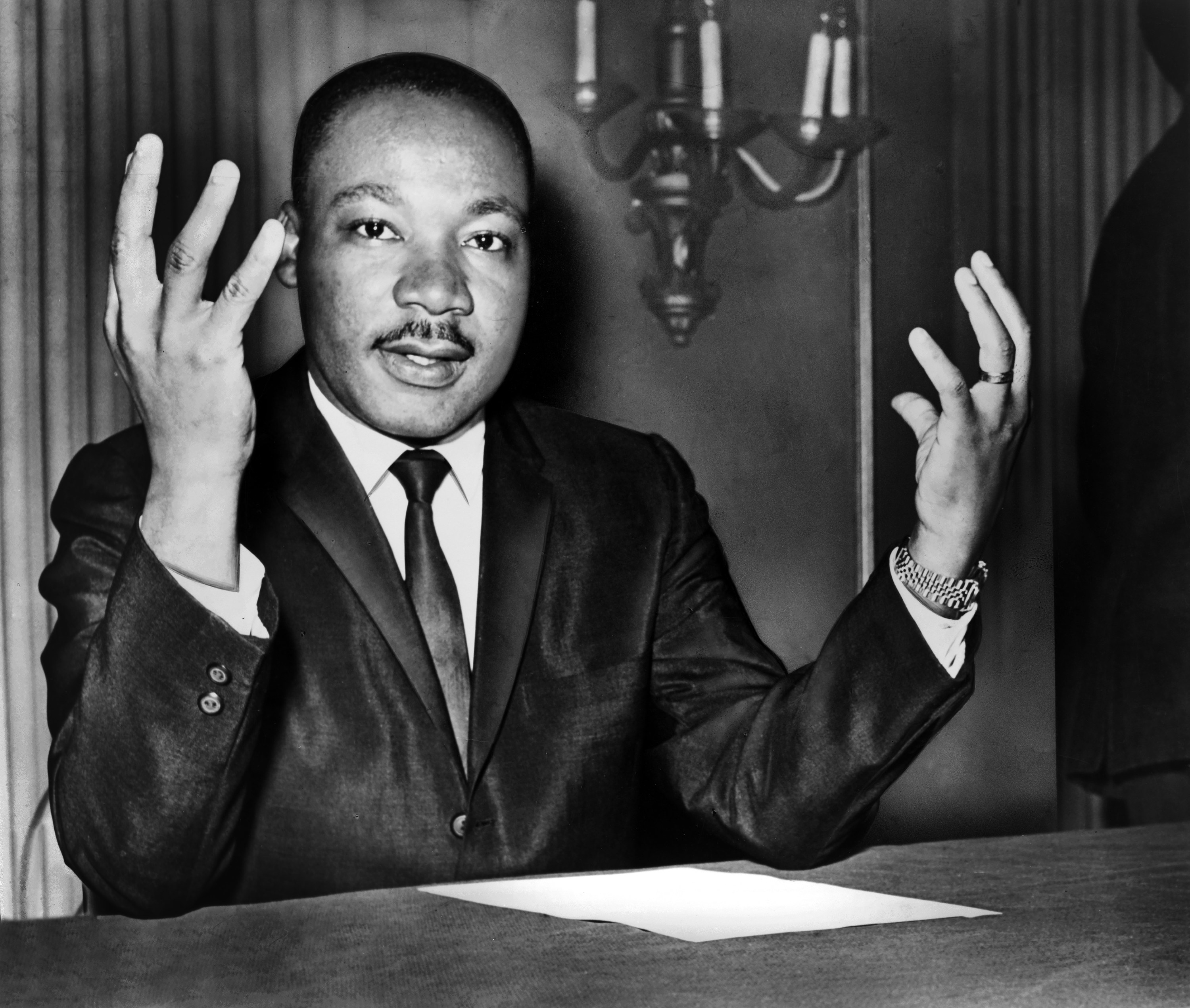 Casual photo of Martin Luther King, Jr. throwing his hands up