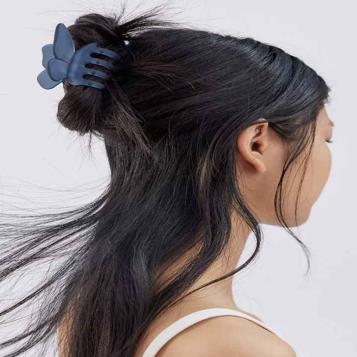 A person wearing the clip in a half updo