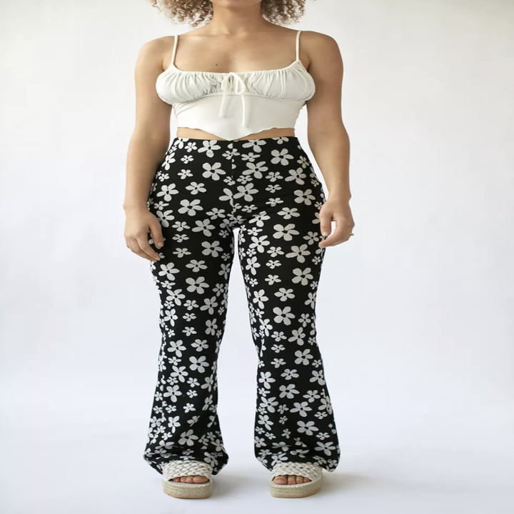 A person wearing the pants with a crop top and sandals