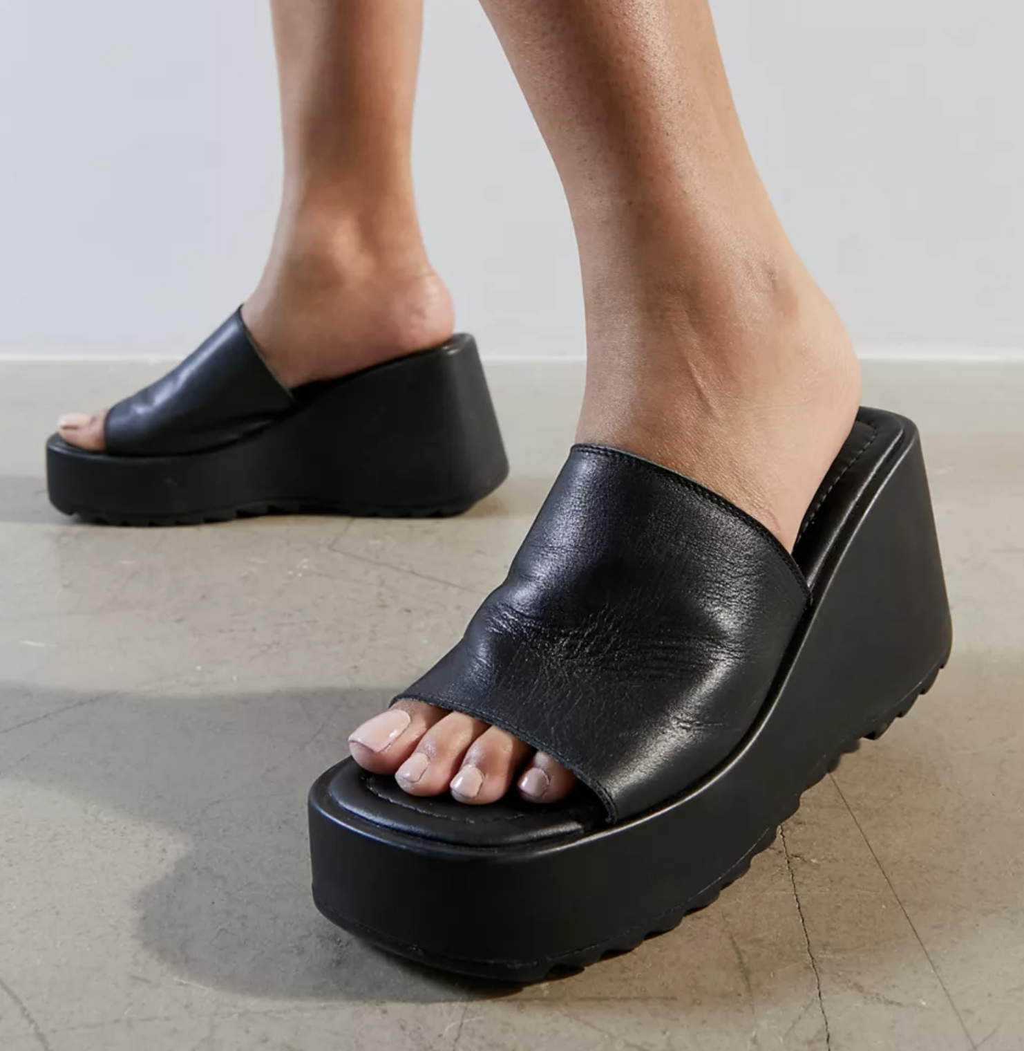 A person wearing the shoes on a concrete floor