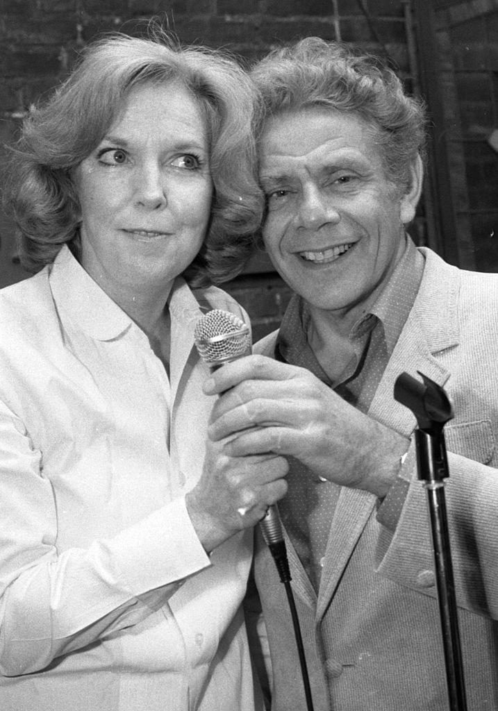 Stiller and Anne Meara posing for a picture in front of a microphone