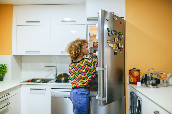 Woman looking inside a refrigerator