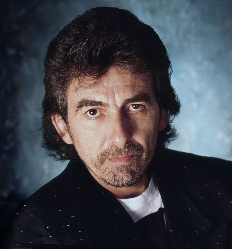 Harrison posing for a portrait for Rolling Stone