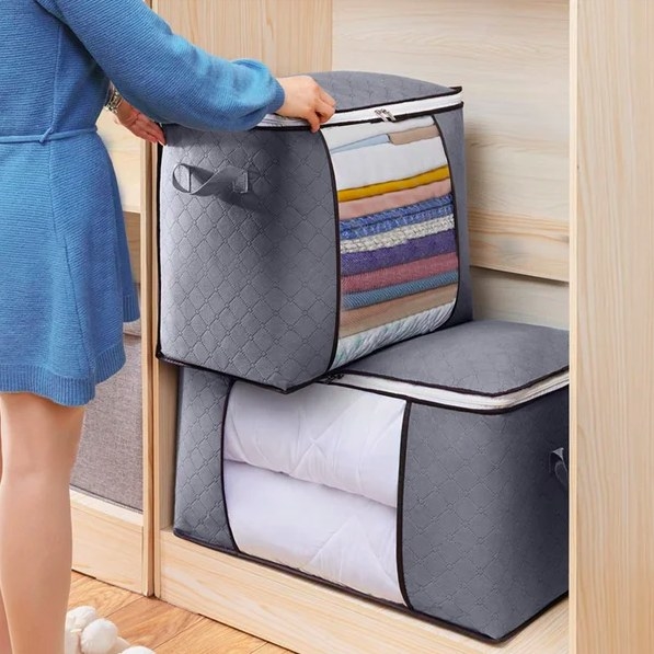 a model stacking the fabric storage containers in a closet
