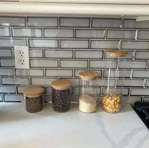 Reviewer of canisters on kitchen counter