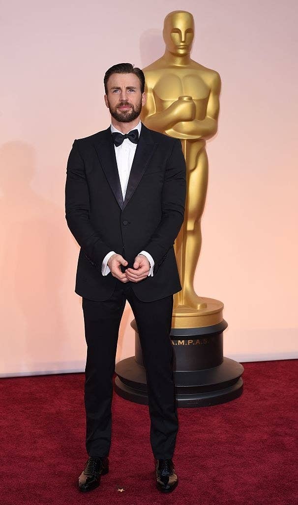 Chris Evans holding his hands together on the red carpet