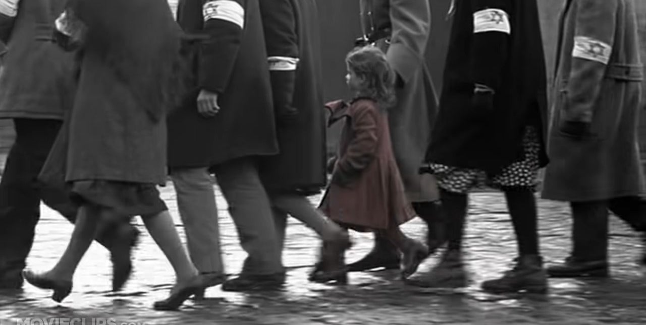 The girl in the red dress walking with a crowd of Jews in &quot;Schindler&#x27;s List&quot;