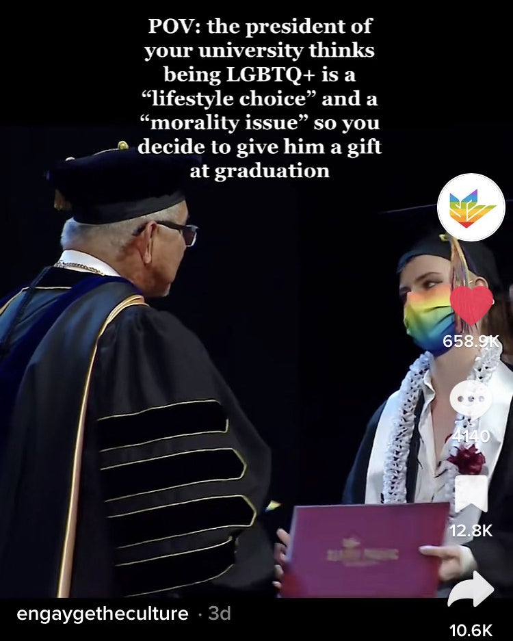 student wearing a rainbow mask at graduation