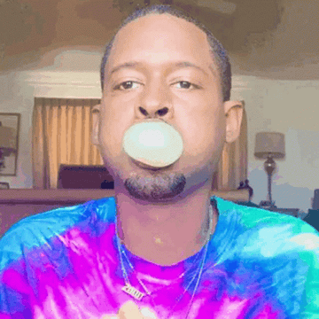 a man blowing a bubble with his gum