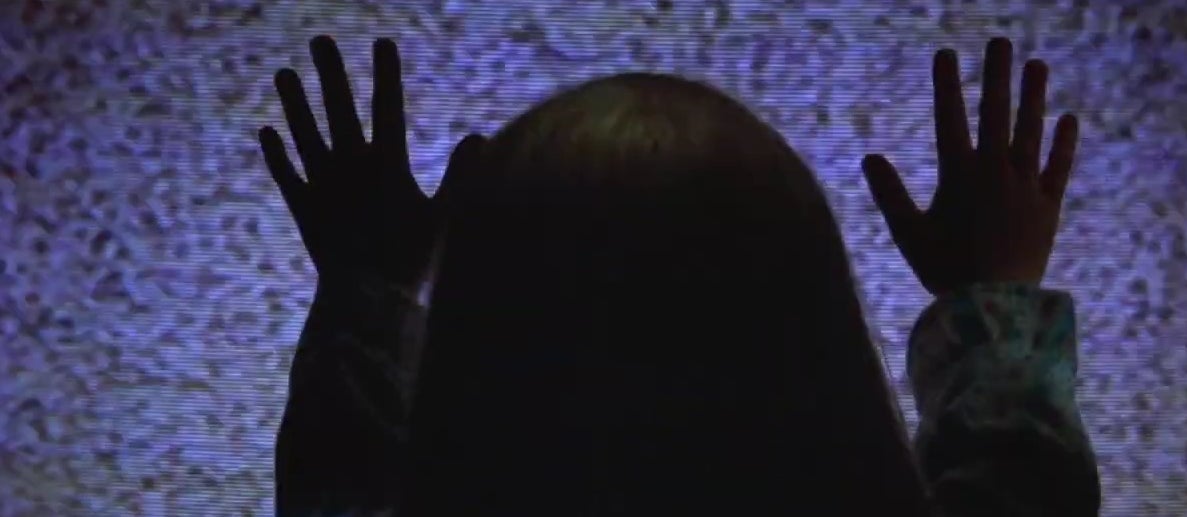 Carol Anne putting her hands on a TV screen in &quot;Poltergeist&quot;