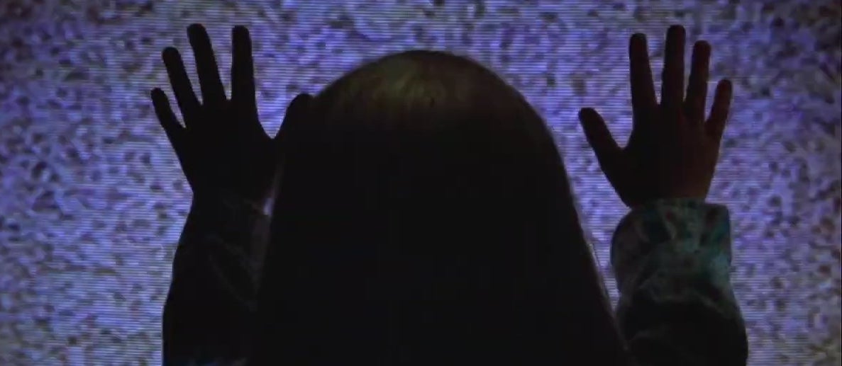 Carol Anne putting her hands on a TV screen in &quot;Poltergeist&quot;