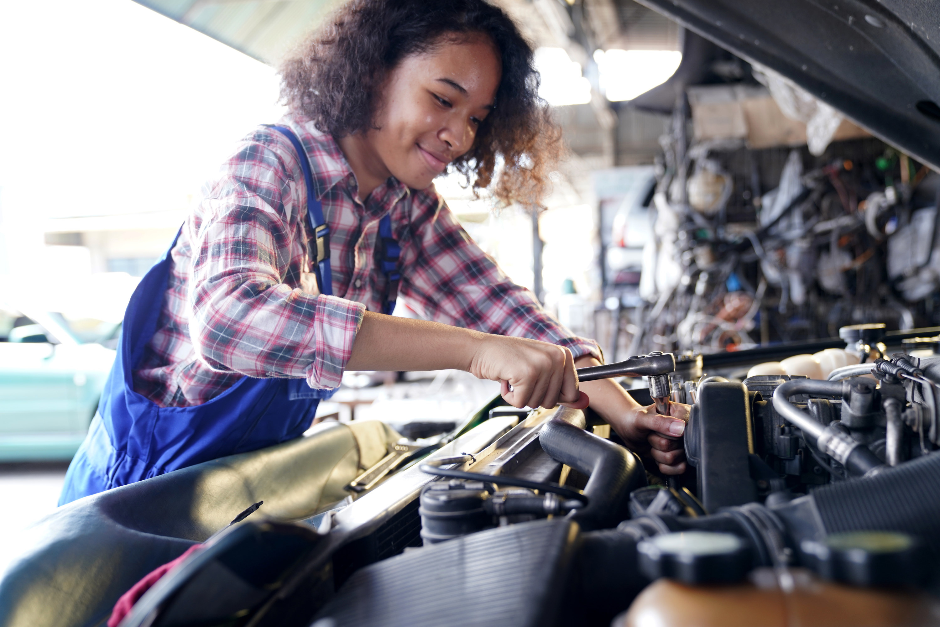 female auto mechanic working on a car