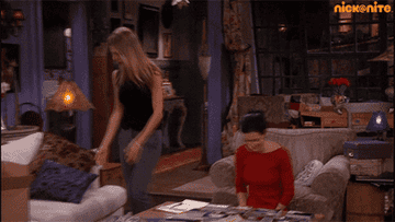 A gif of Rachel from Friends dumping trash on a coffee table