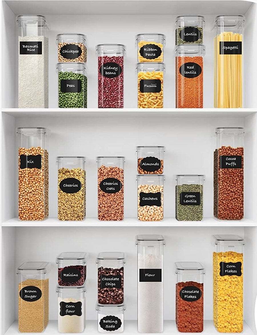 the storage containers with labels on them in a pantry