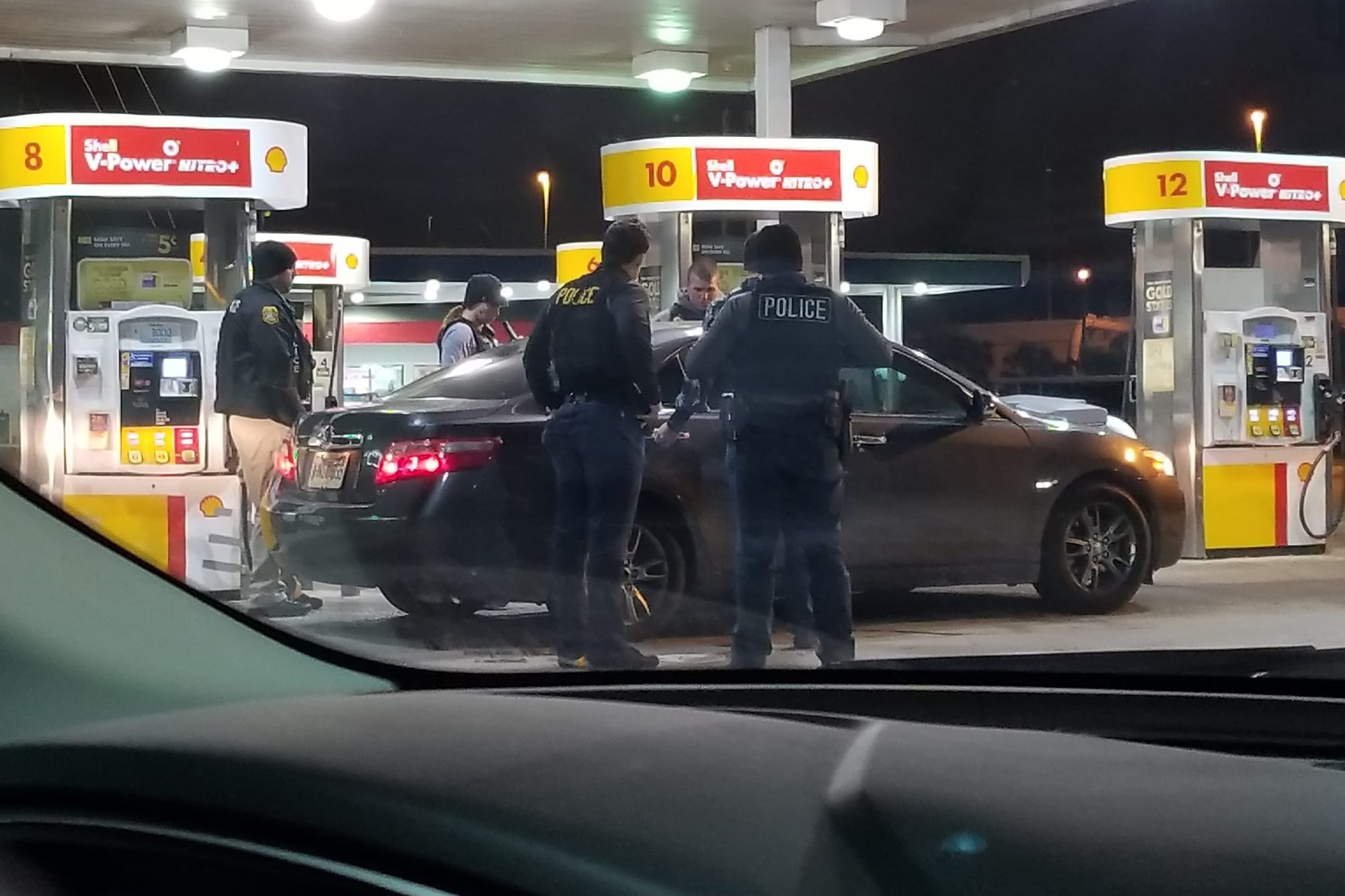 An image that Jerry Wyche took of police officers standing around a compact car at a gas station