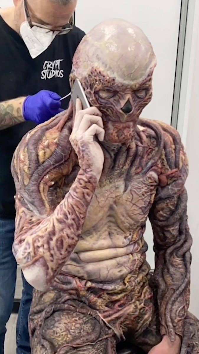 a person in a monster-like skeleton suit on the phone