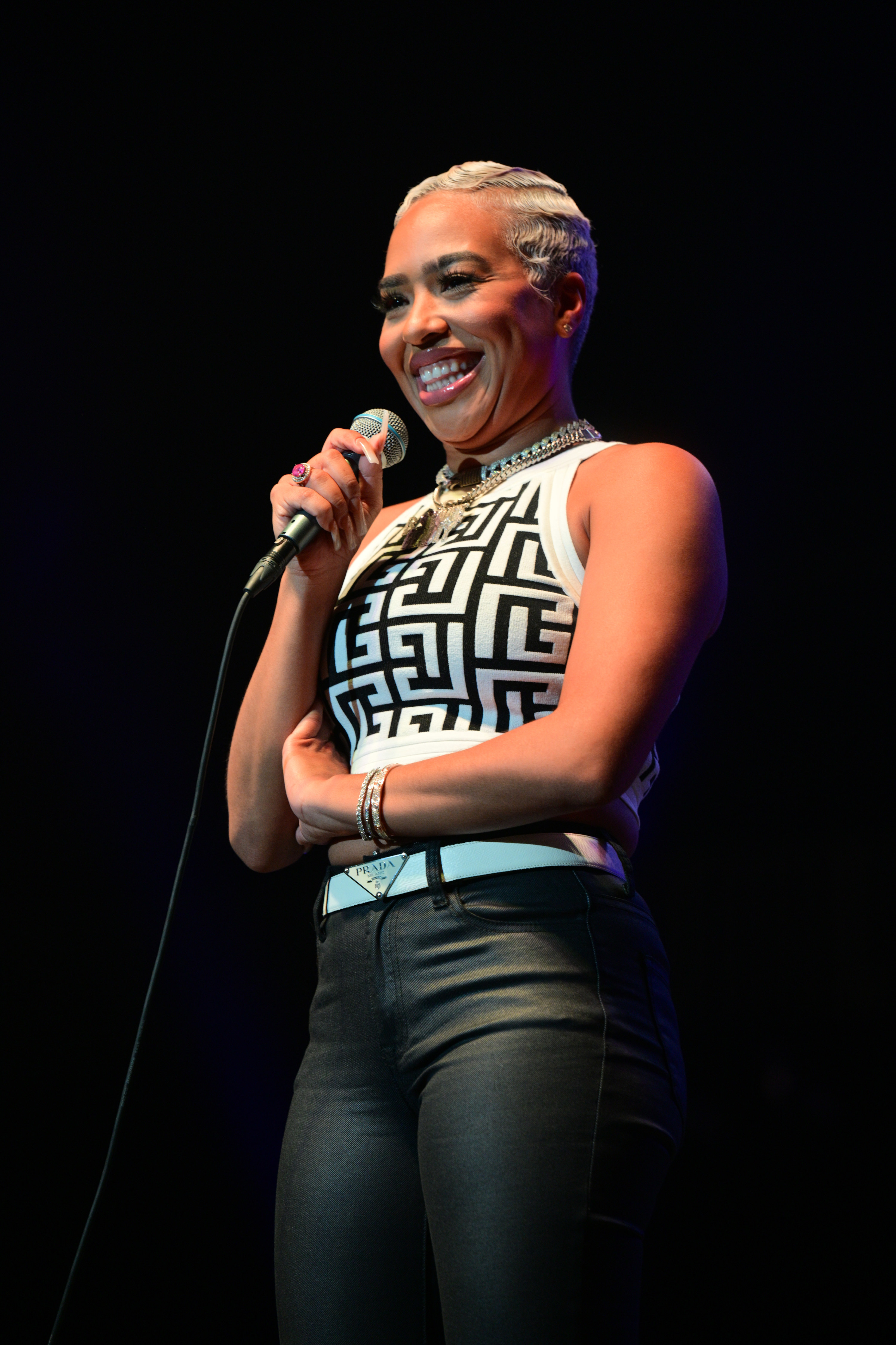 B Simone smiling while talking with a microphone in her hand