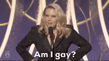 Kate McKinnon talking at a mic and saying, &quot;Am I gay?&quot;