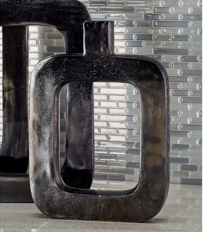 the black rectangular vase against a tiled backsplash