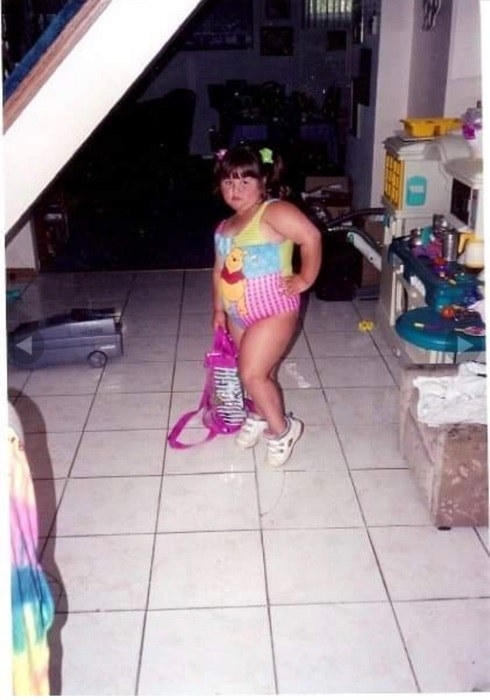 young girl posing with a winnie the pooh swim suit