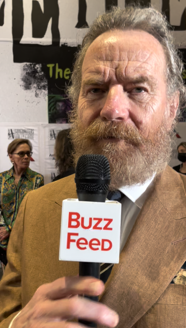 Close-up of Bryan with a beard and a BuzzFeed microphone in front of him