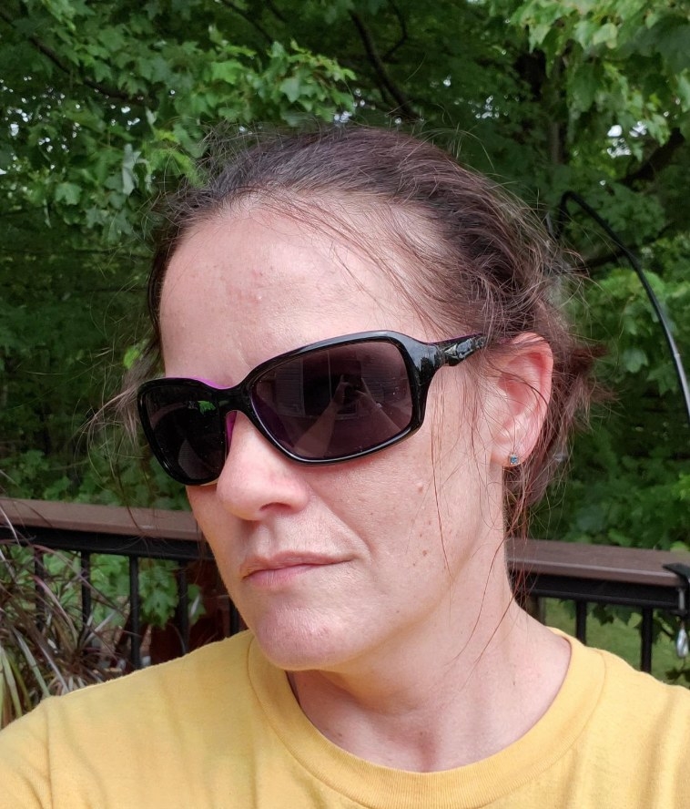 A reviewer wearing black sunglasses and yellow shirt